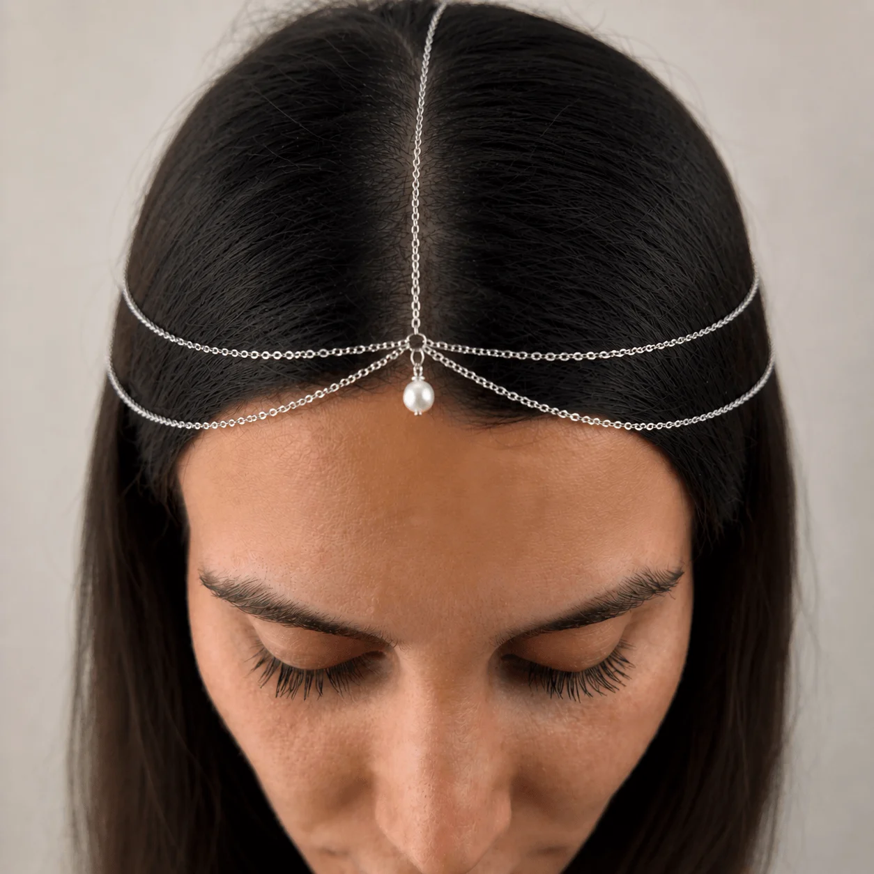 Delicate gold-tone stainless steel pearl bridal head chain draped across hairline for wedding hairstyles