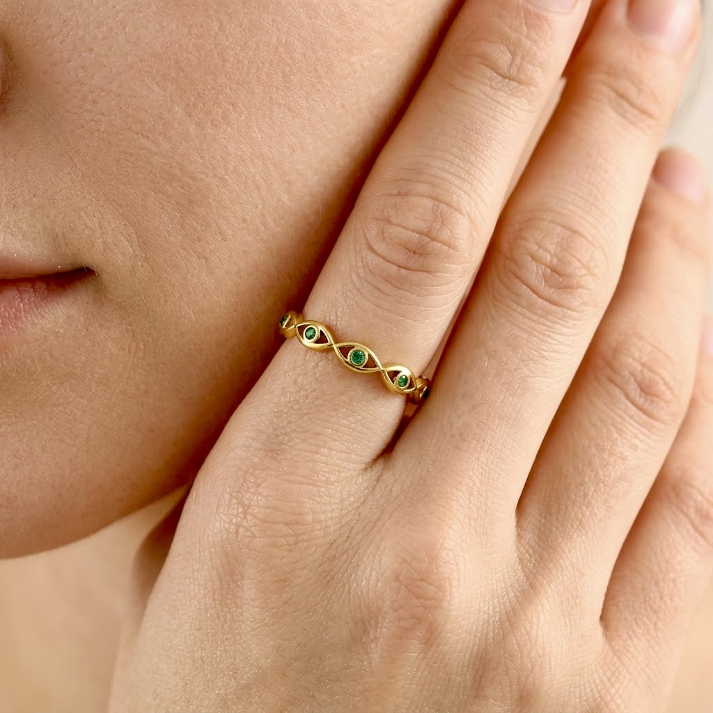 Gold evil eye woven band ring with green cubic zirconia gemstones, adjustable stainless steel ring