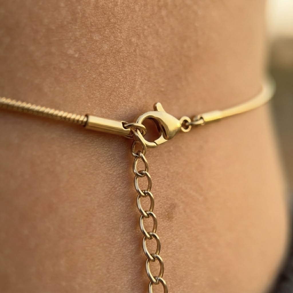 Gold tone stainless steel snake belly chain draped on waist, minimalist summer jewelry accessory