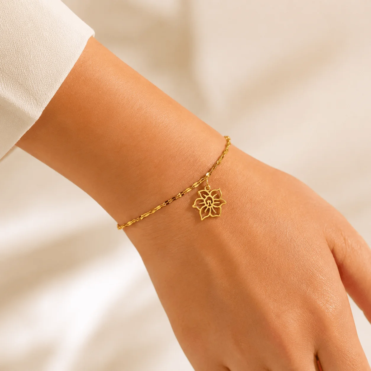 Dainty stainless steel birth flower charm bracelet in gold tone, handcrafted tarnish-resistant jewelry for everyday wear
