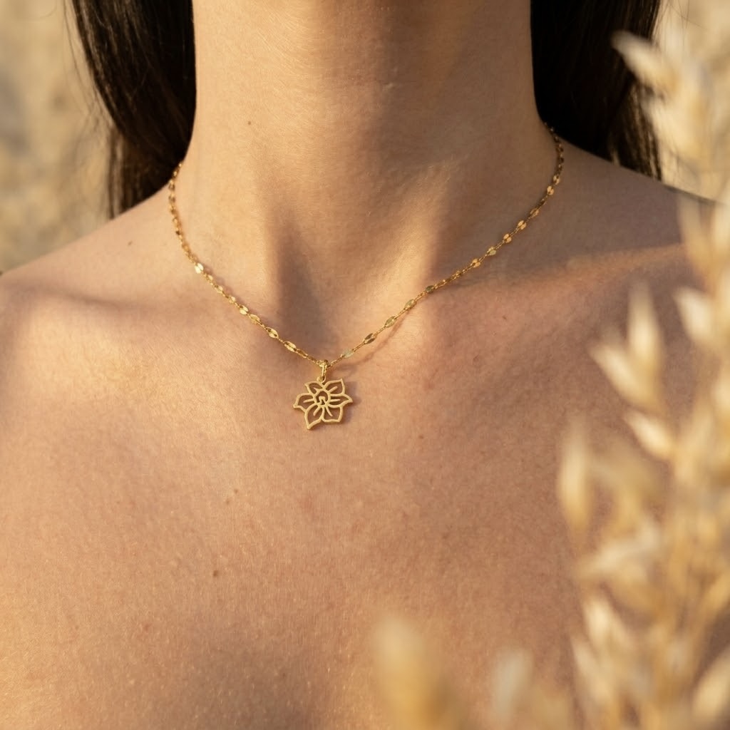Delicate gold tone birth flower pendant necklace in stainless steel, handcrafted dainty charm necklace for everyday wear.