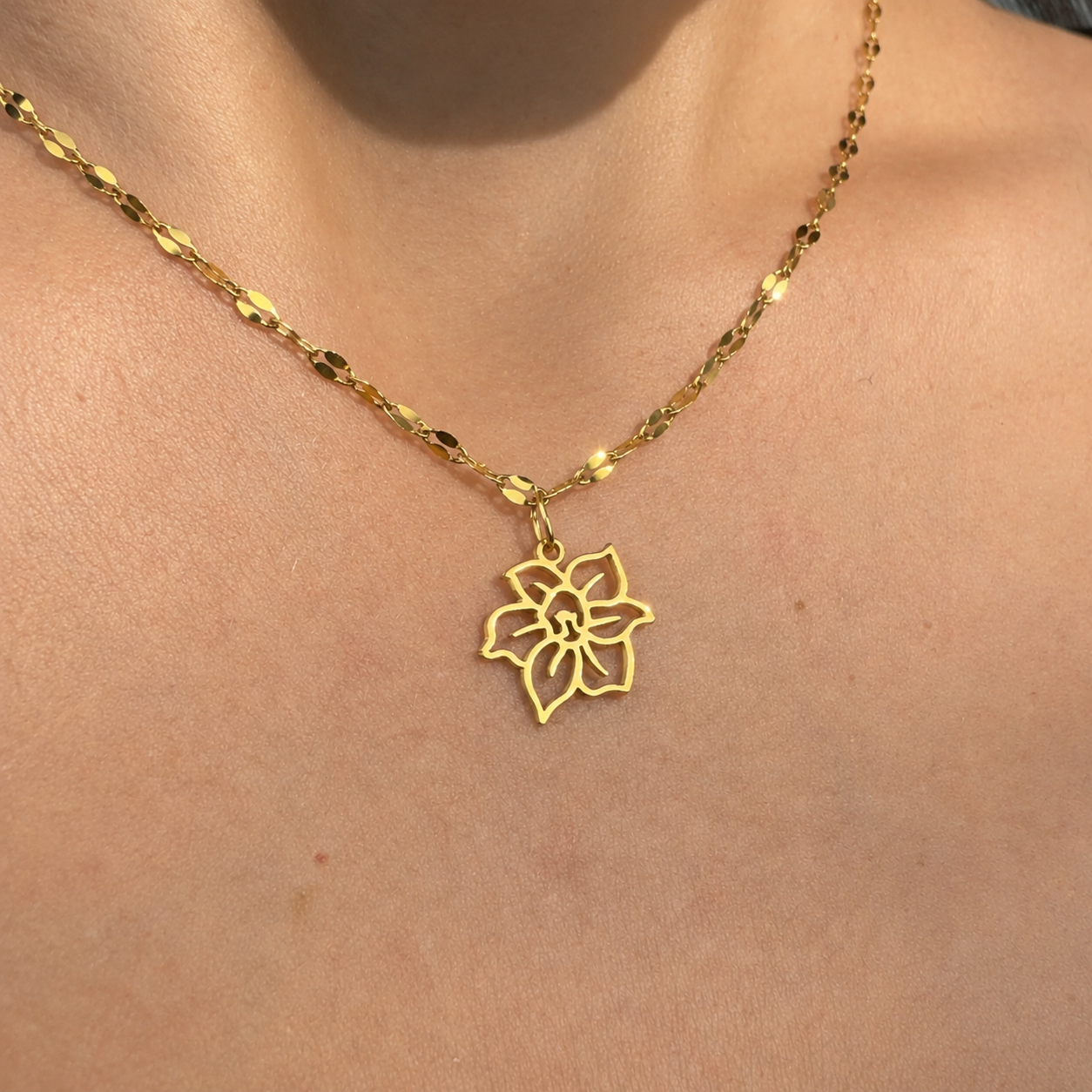 Delicate gold tone birth flower pendant necklace in stainless steel, handcrafted dainty charm necklace for everyday wear.