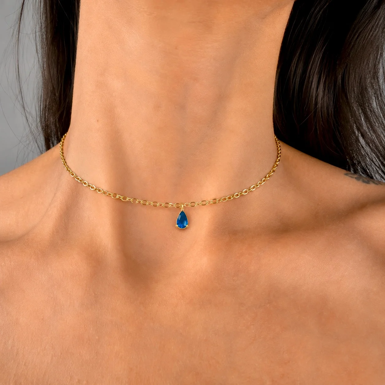 Delicate gold-tone birth month teardrop choker necklace with gemstone pendant, stainless steel waterproof design