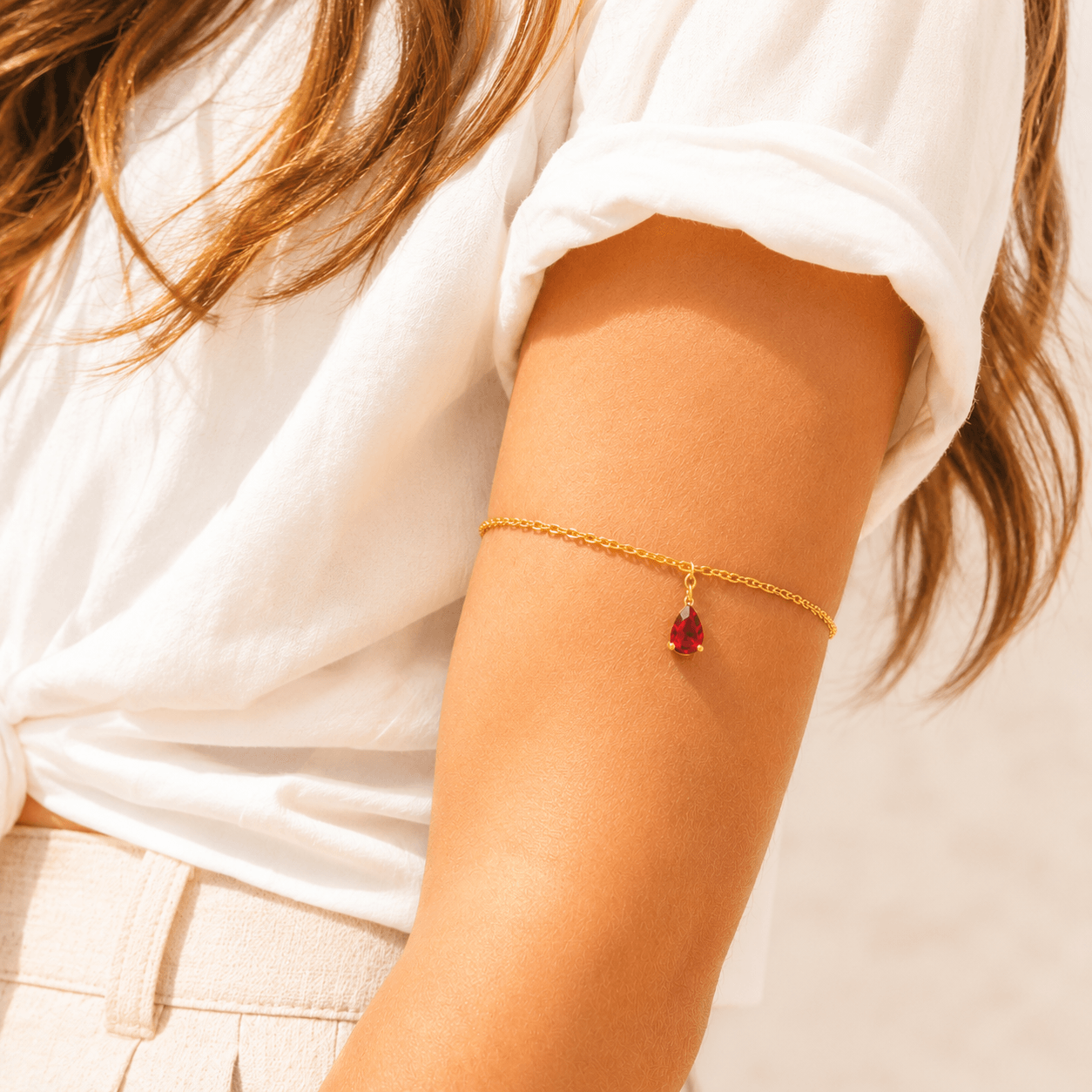 Dainty single-strand gold stainless steel birthstone arm band with teardrop gemstone, waterproof upper arm jewelry
