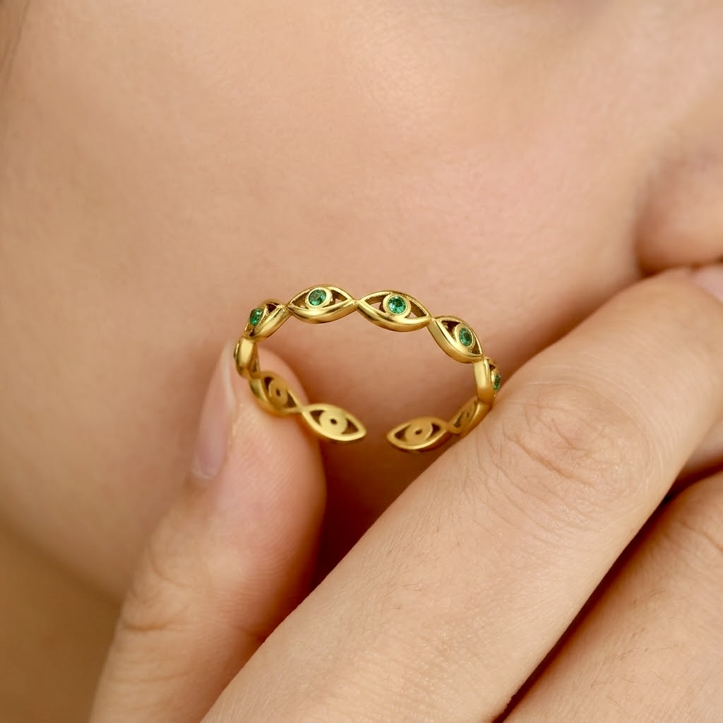 Gold evil eye woven band ring with green cubic zirconia gemstones, adjustable stainless steel ring