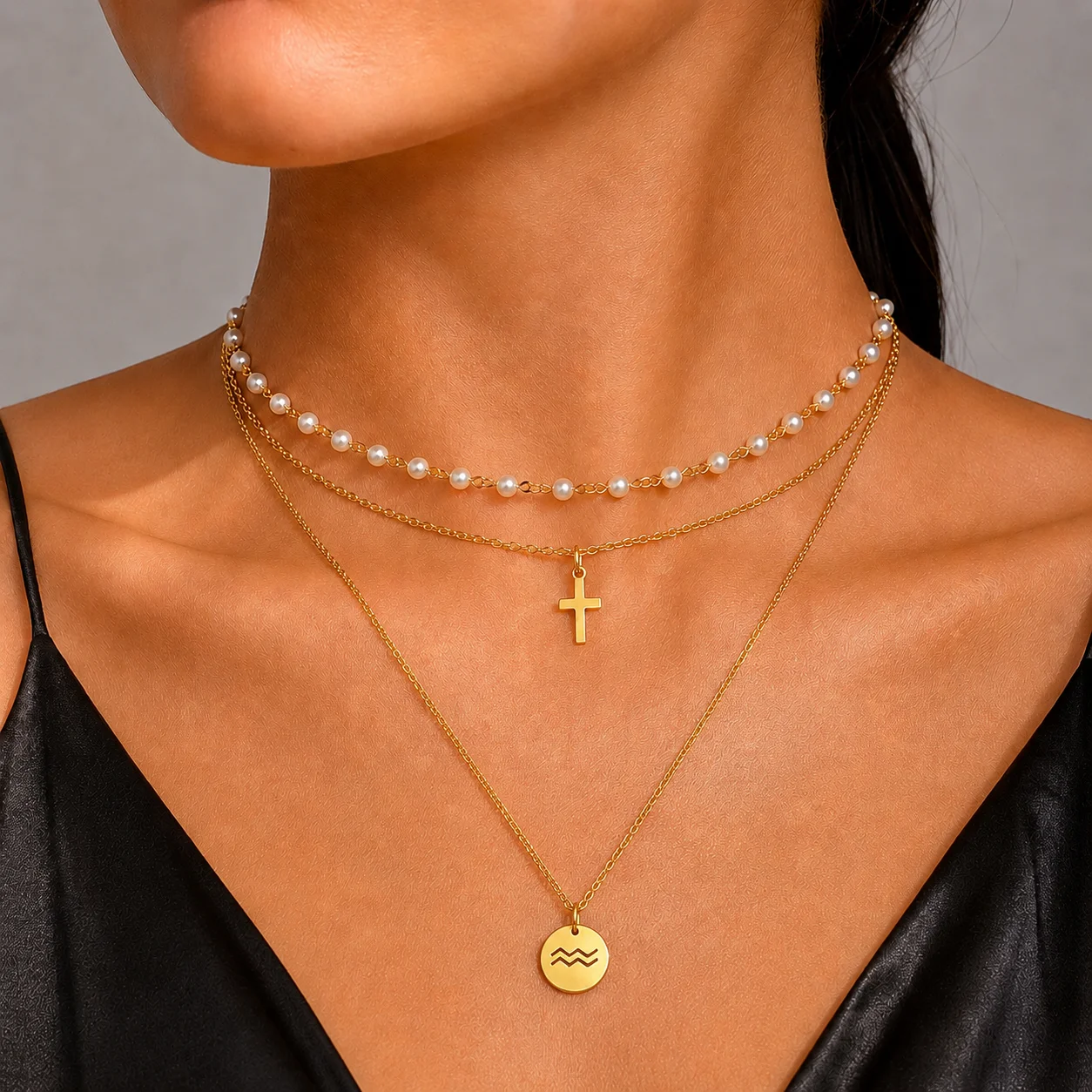 Layered necklace set with faux pearl choker, cross pendant chain, and zodiac pendant necklace in waterproof gold or silver stainless steel