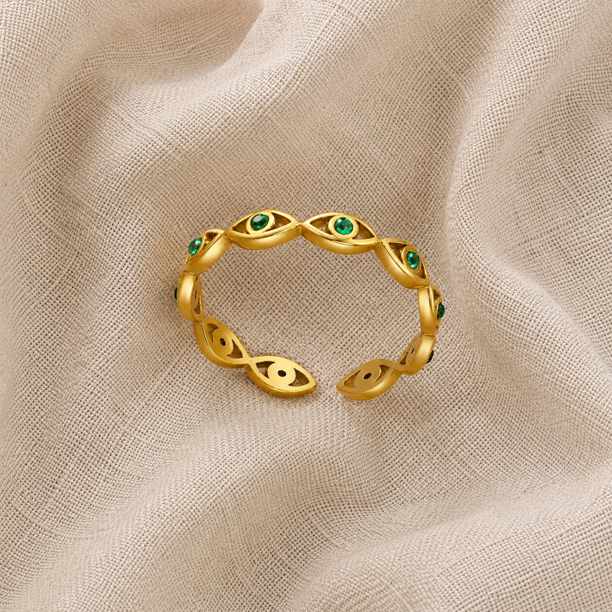 Gold evil eye woven band ring with green cubic zirconia gemstones, adjustable stainless steel ring