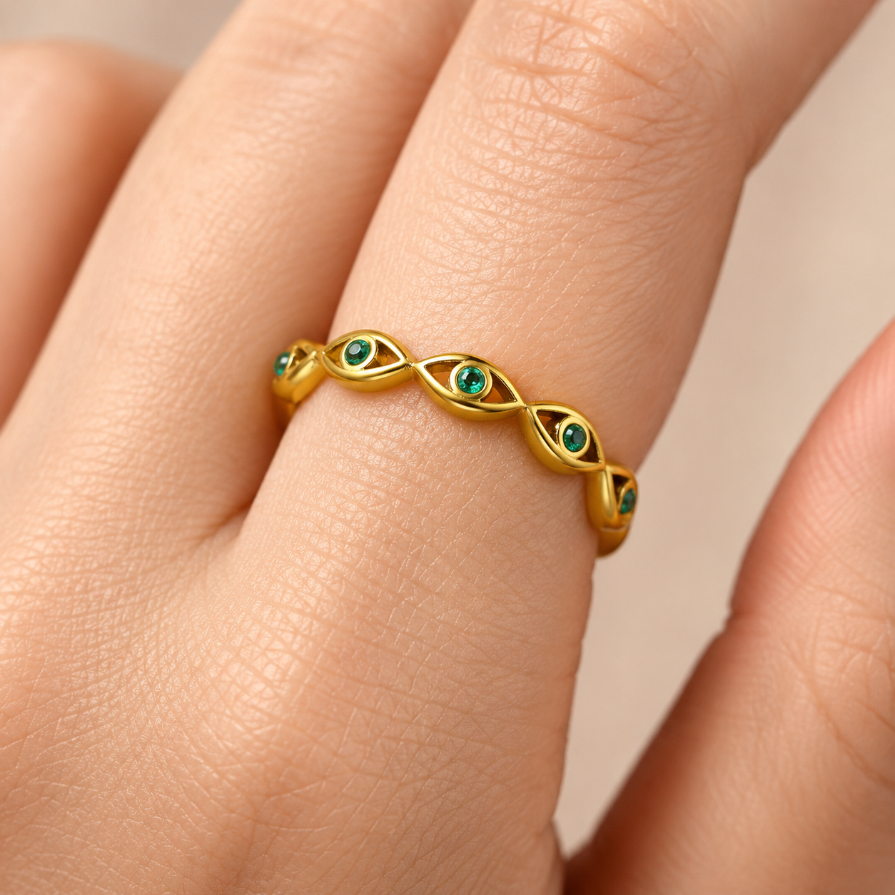 Gold evil eye woven band ring with green cubic zirconia gemstones, adjustable stainless steel ring
