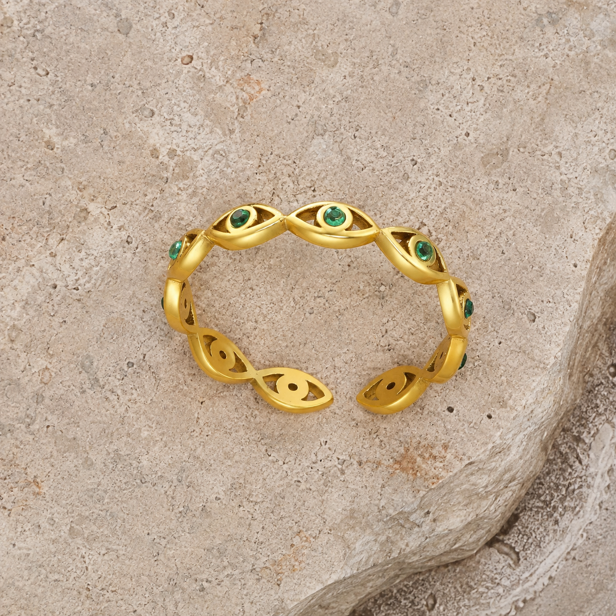 Gold evil eye woven band ring with green cubic zirconia gemstones, adjustable stainless steel ring