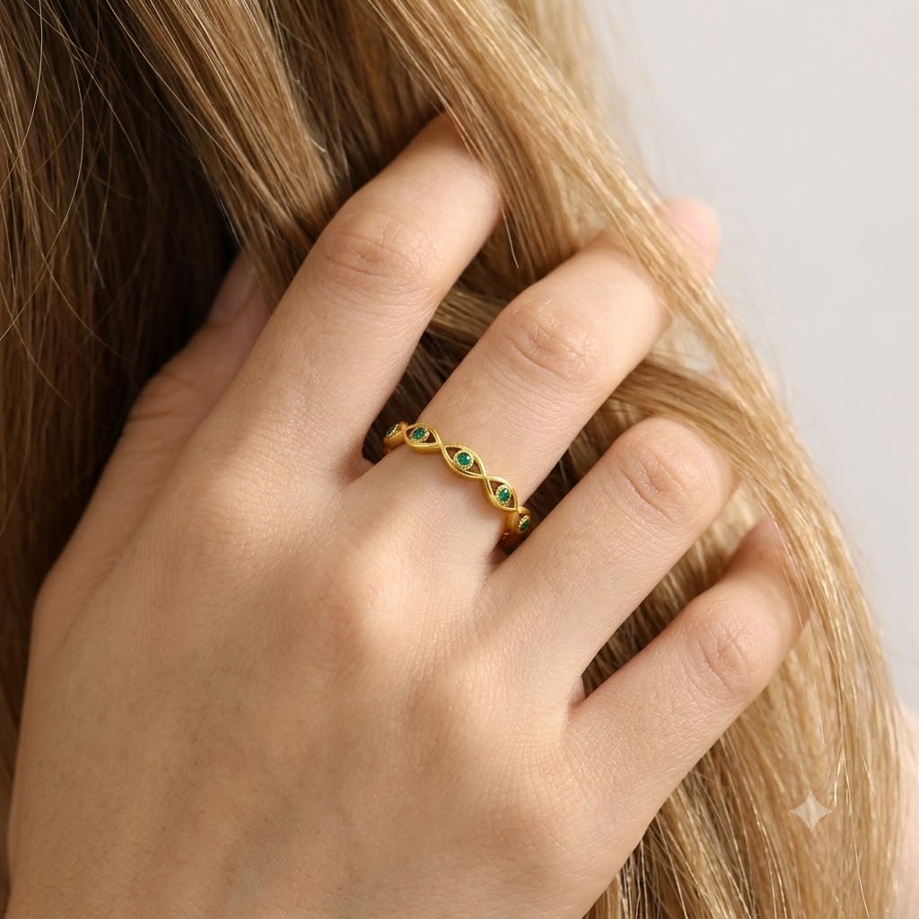 Gold evil eye woven band ring with green cubic zirconia gemstones, adjustable stainless steel ring