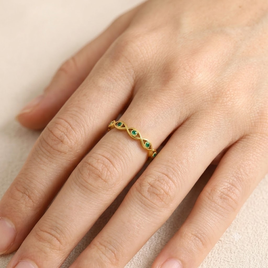 Gold evil eye woven band ring with green cubic zirconia gemstones, adjustable stainless steel ring