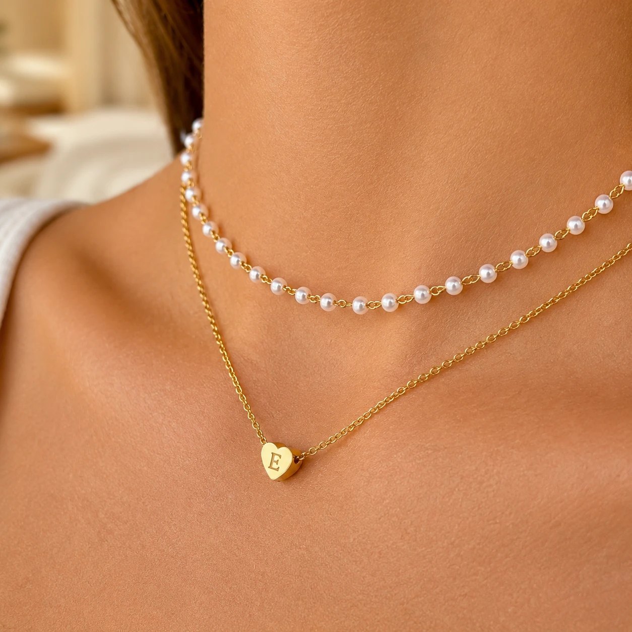 Personalized initial heart pendant necklace layered with pearl bead chain, gold-tone stainless steel choker