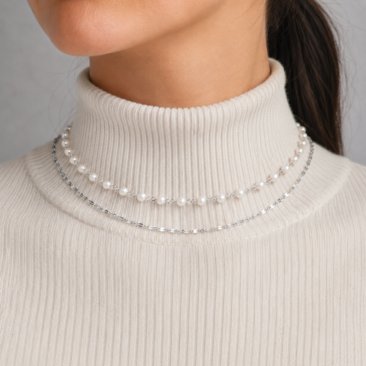 Dainty pearl bead choker necklace layered with a fine gold-tone or silver-tone cable chain in waterproof stainless steel