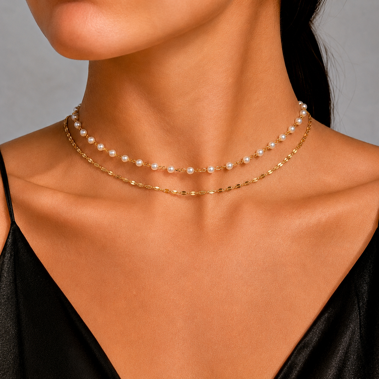 Dainty pearl bead choker necklace layered with a fine gold-tone or silver-tone cable chain in waterproof stainless steel