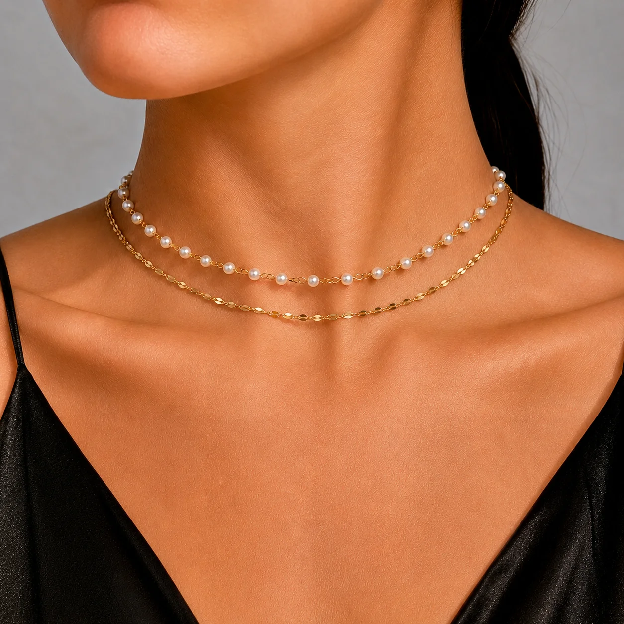 Dainty pearl bead choker necklace layered with a fine gold-tone or silver-tone cable chain in waterproof stainless steel