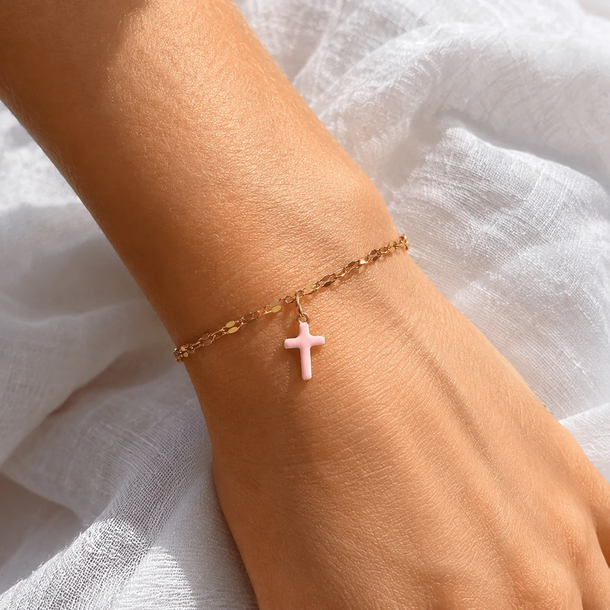 Delicate gold stainless steel bracelet with pink cross charm, dainty faith jewelry for everyday wear